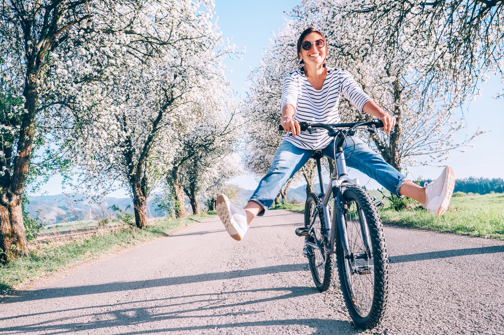 Happy,Smiling,Woman,Cheerfully,Spreads,Legs,On,Bicycle,On,The