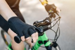 Cropped,Shot,Of,Cyclist,Hand,Wearing,Glove,And,Holding,A
