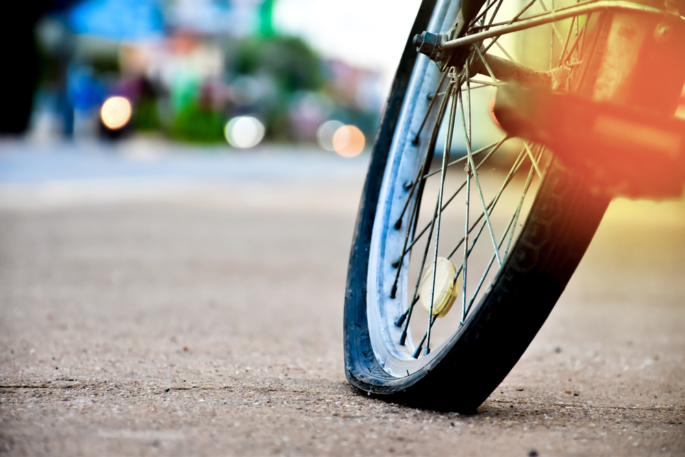 An,Old,Bike,That,Has,Back,Flat,Tire,Parked,By