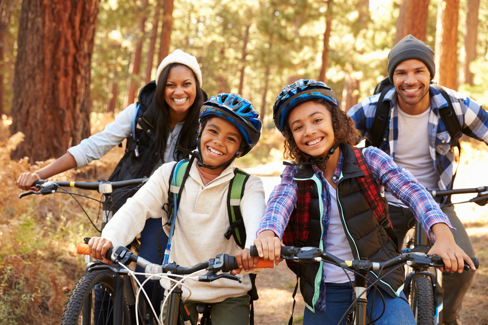 Portrait,Of,Family,Cycling,Through,Fall,Woodland