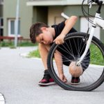 Sad,Boy,Looking,At,His,Flat,Bike,Tire,,Kid,Staring