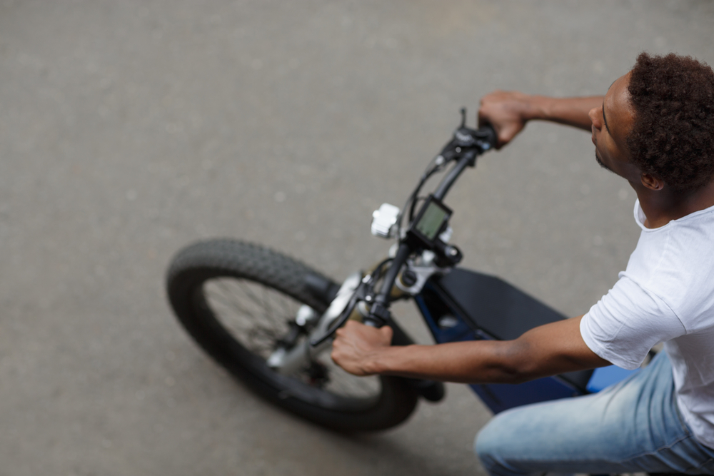 Top,View,Of,Young,Man,Riding,Electric,Bike,Along,The