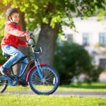 Child,On,A,Bicycle,At,Asphalt,Road,In,Summer.,Bike