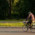 A,Man,On,A,Tricycle,Against,A,Tree,Background.,High